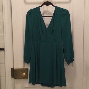 Green express skater dress with v-neck front and long sleeves
